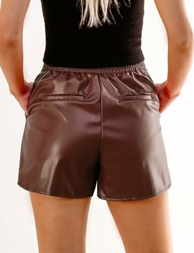 Back view of person wearing brown leather shorts