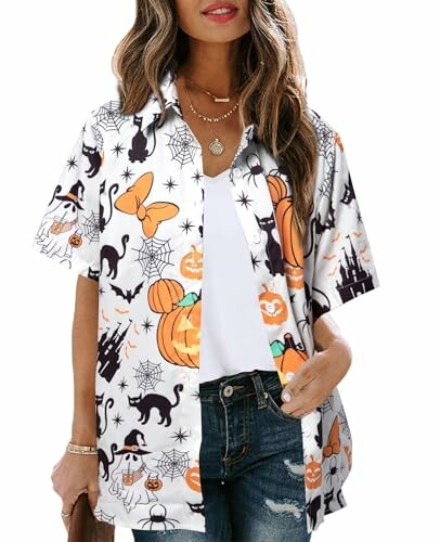 Woman wearing a Halloween-themed shirt with pumpkins and bats.