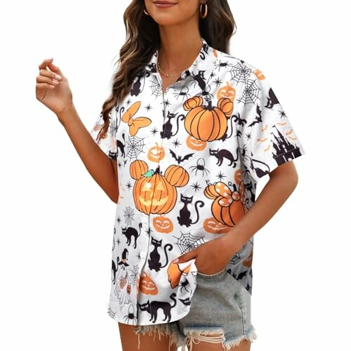 Woman wearing a Halloween-themed shirt with pumpkins and spiders.