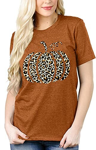 Woman wearing a brown t-shirt with a leopard print pumpkin design.