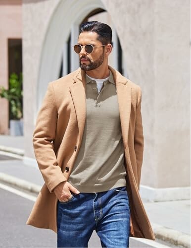 Man in a camel coat and sunglasses walking on the street.