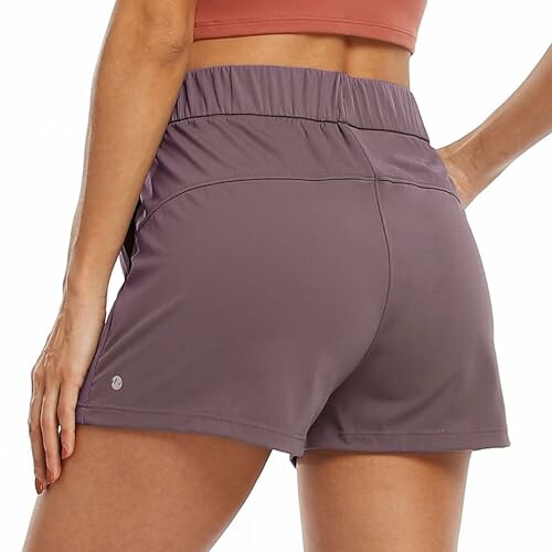 Woman in purple athletic shorts.